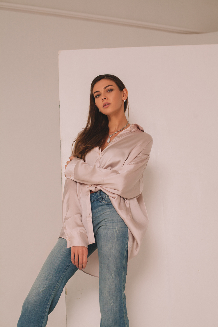 A Woman Wearing Beige Blouse and Denim Pants